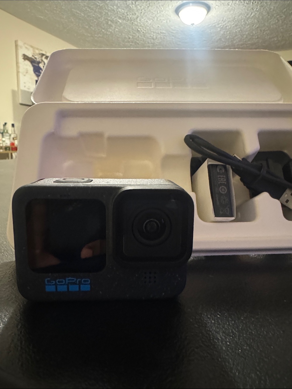 GoPro Black Action Camera with Blue Logo and Accessories